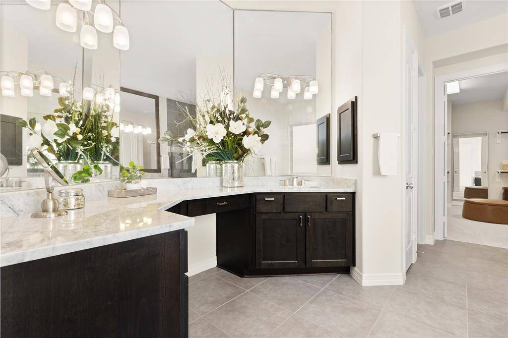 Elegant marble countertops on spacious vanities.