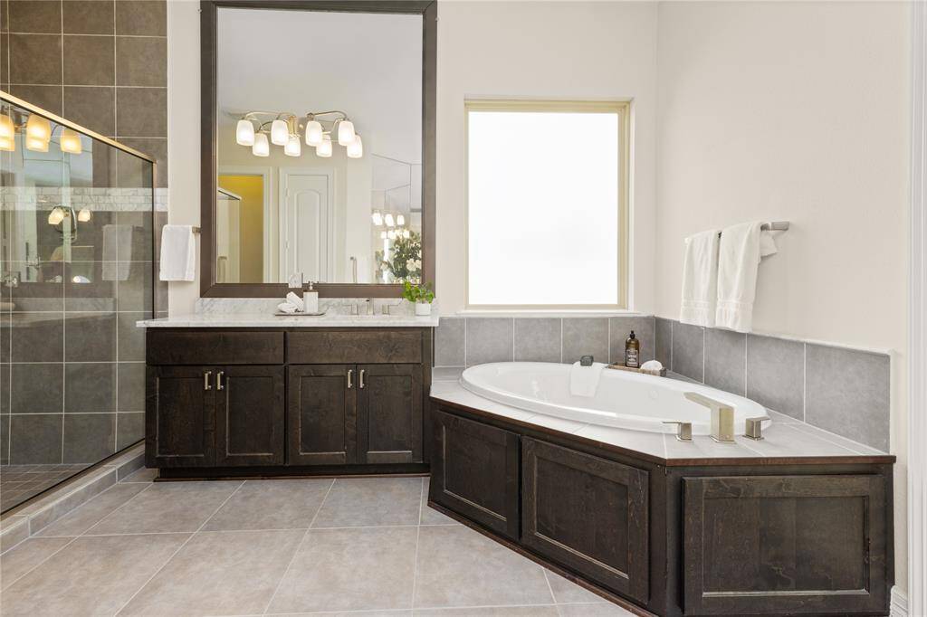 Indulge in relaxation with a luxurious jetted tub and two separate vanities for convenience.