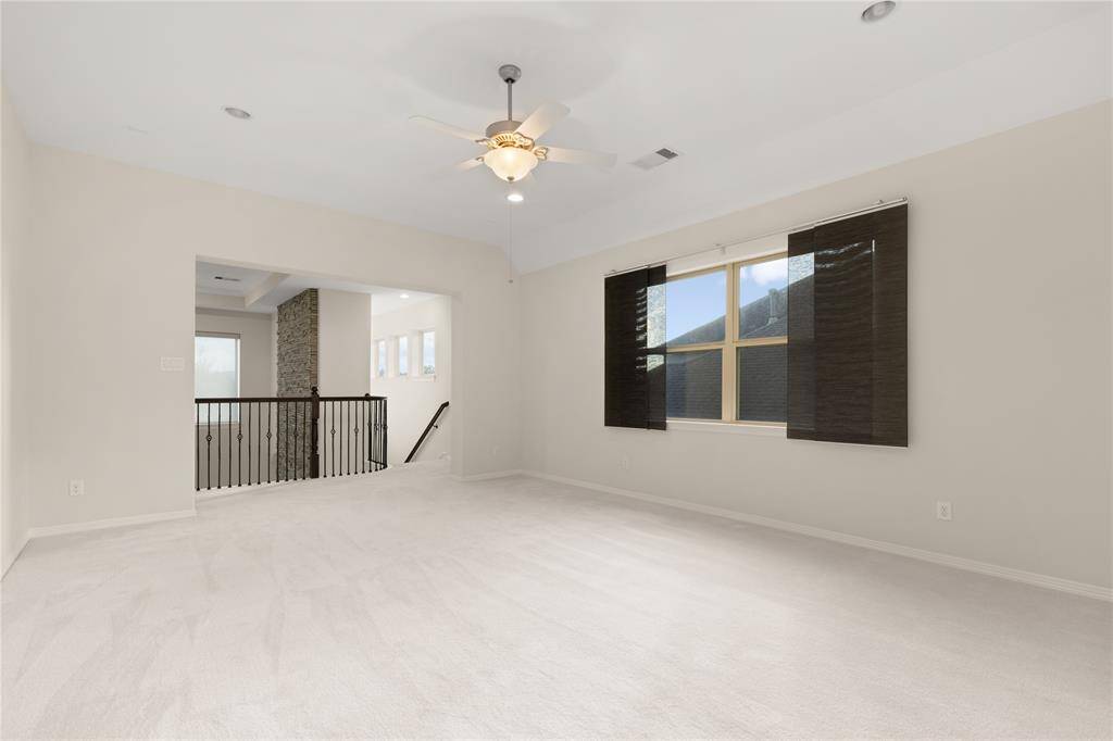 Expansive flex room at the top of the back staircase, perfect for a game or playroom, with a convenient closet for storage.