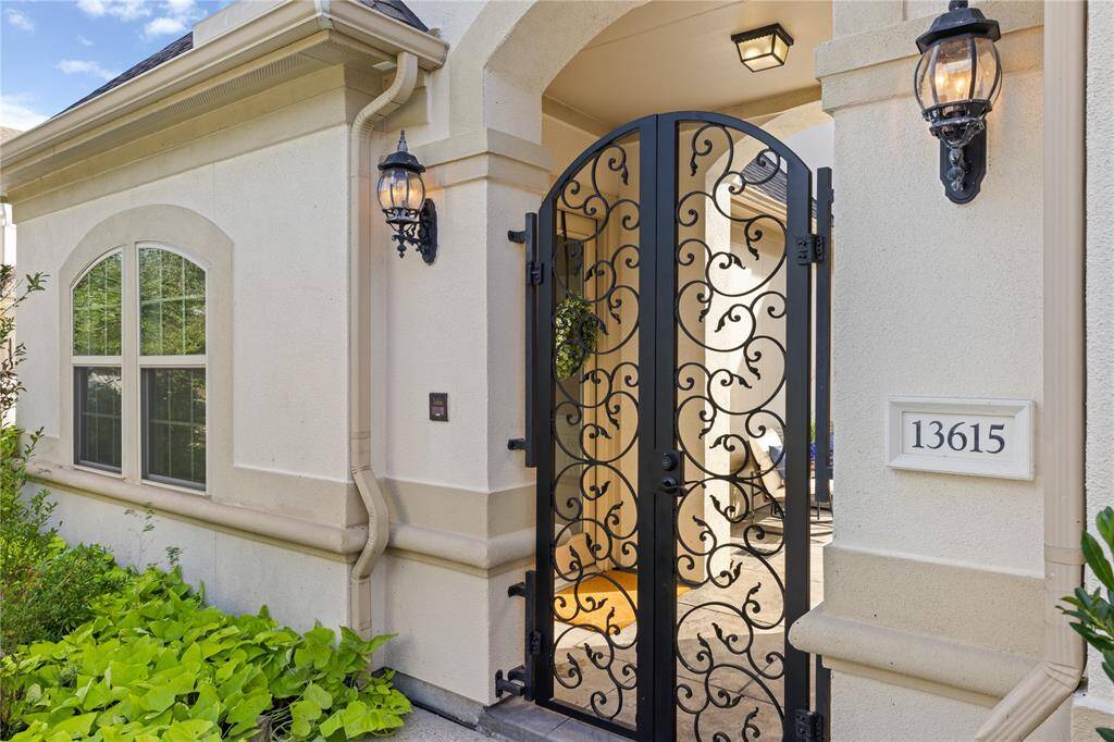 Step through an elegant wrought iron gate into a welcoming courtyard.