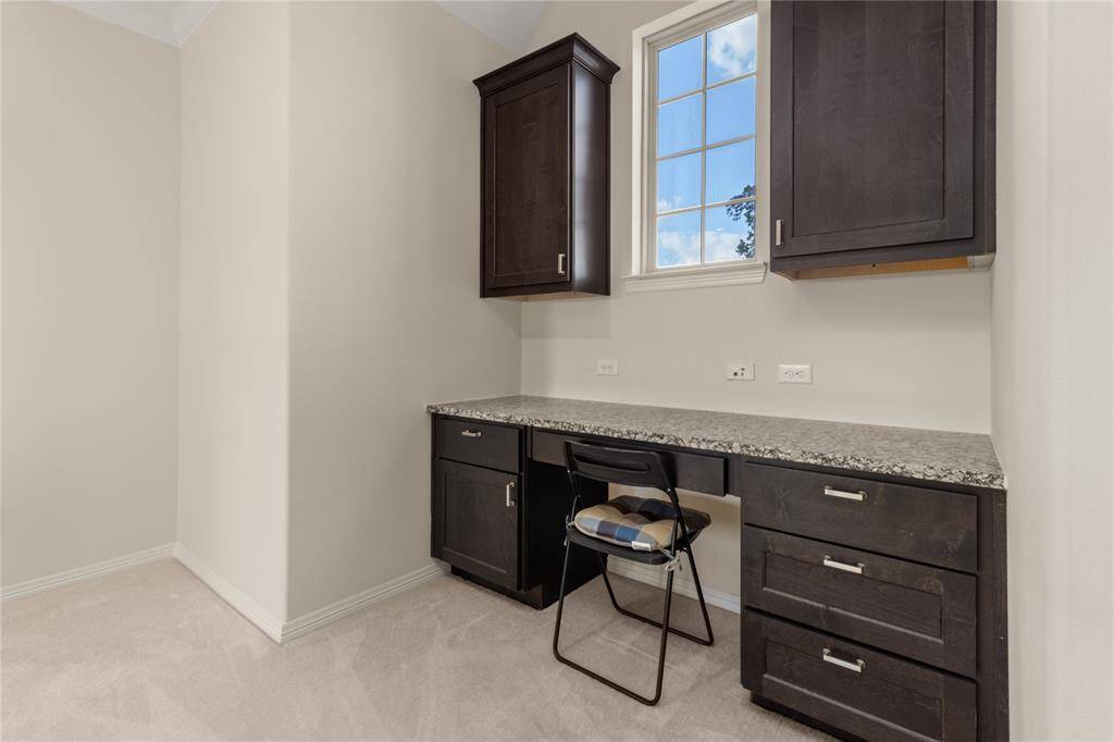Convenient built-in workstation featuring a sleek granite countertop and ample drawer storage.