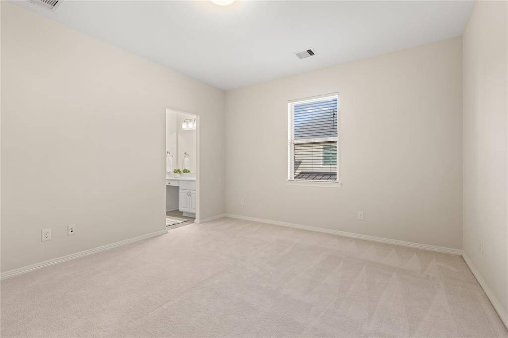 Two additional bedrooms are located down the hall, offering privacy and sharing a Hollywood full bath.