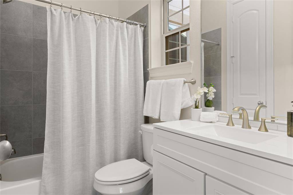 Spacious full bathroom with convenient linen closet.