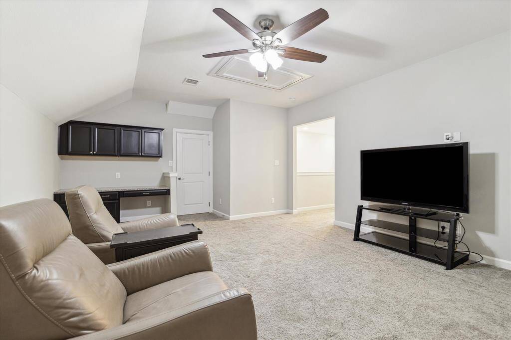 Expansive game room or media room with a built-in desk. Don't forget to check out that impressive attic space!