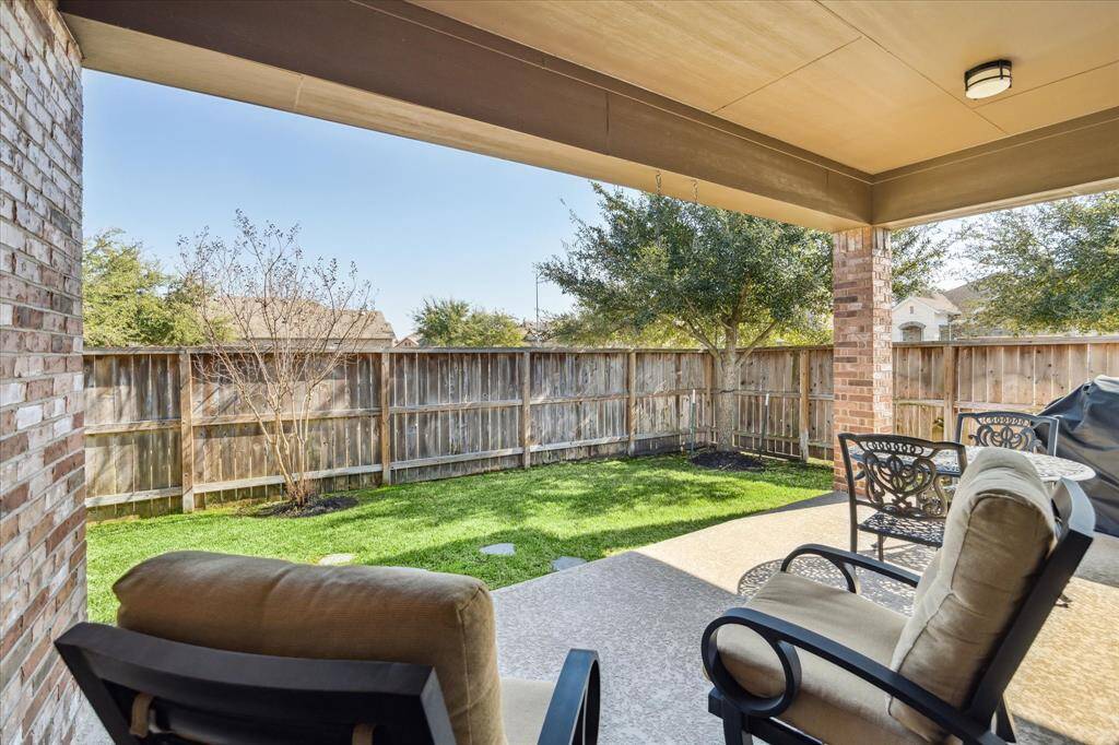 Covered patio with plenty of space for a comfortable outdoor living area.