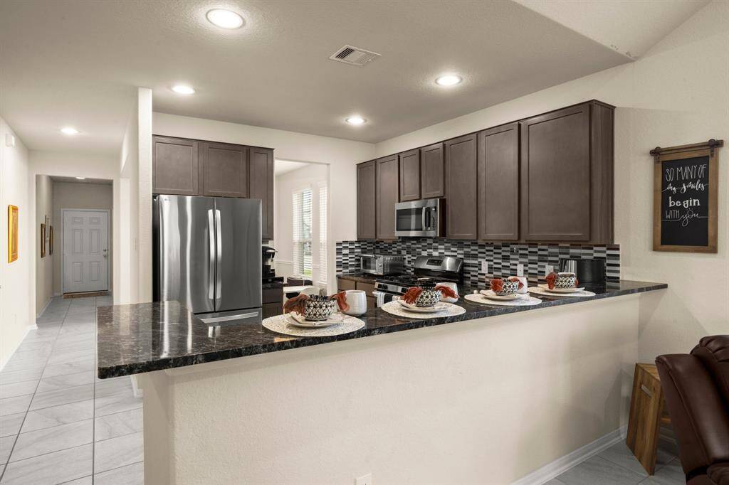 The breakfast bar creates an additional seating space for conversation and functionality.