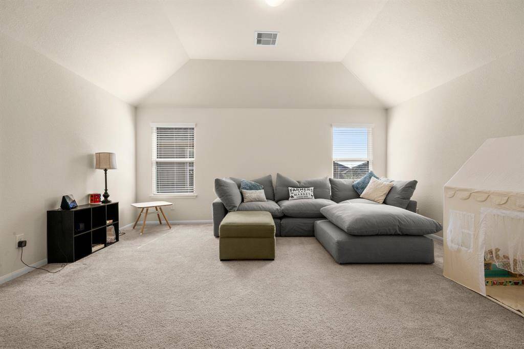 Up the stairs you will welcomed by the high ceiling in the large game room.  Watch a sporting event or just read a book to relax!