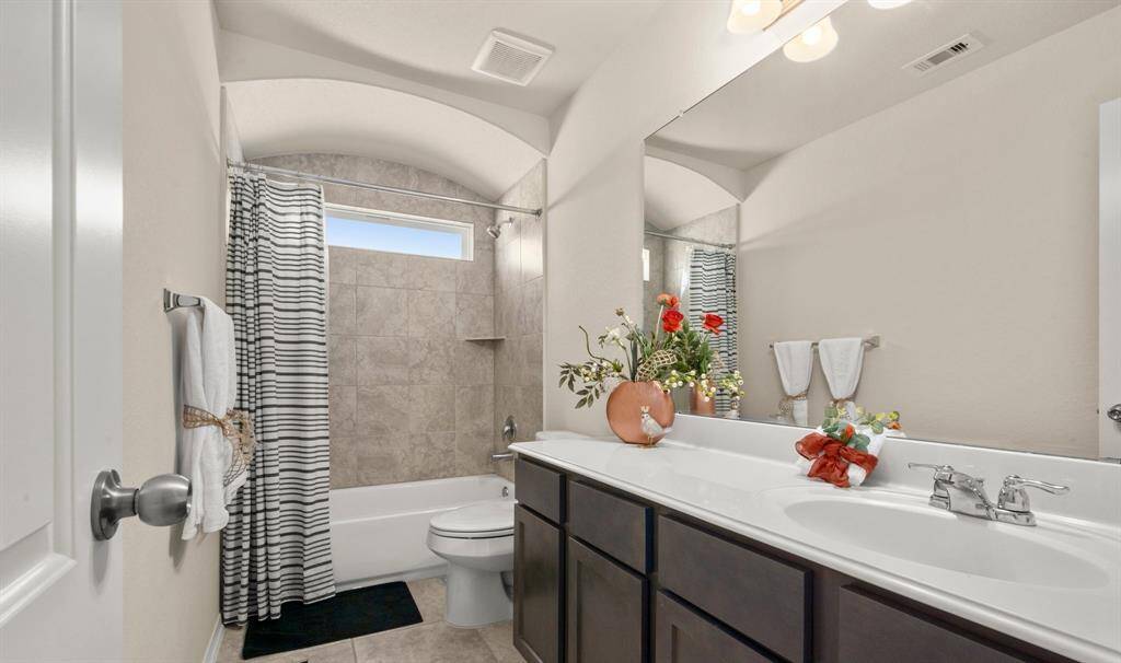 The shared full bathroom upstairs has plenty of room and storage.