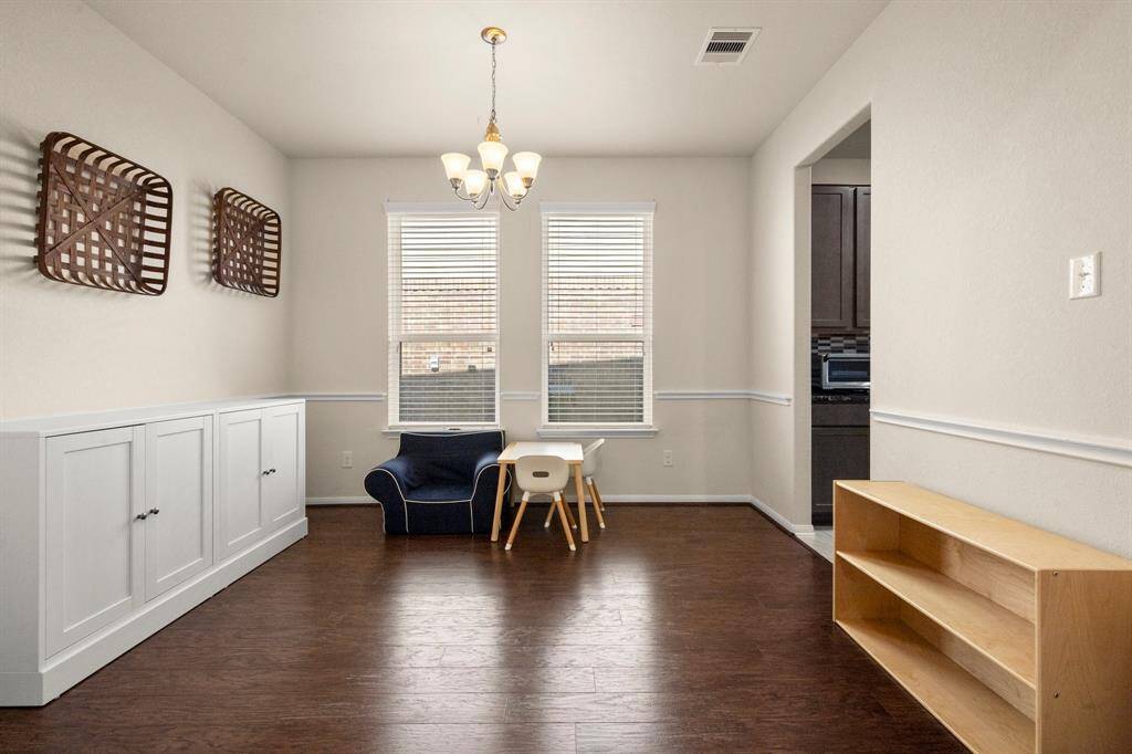 The beautiful formal dining room has a laminate floor giving the room a rich tone with the natural light.
