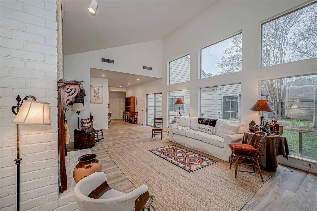 Light and bright family room, wide plank wood look tile throughout the home.