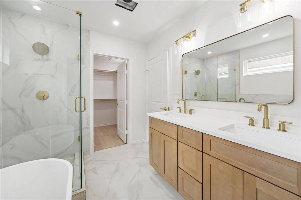 Primary bath with stand up shower, soaking tub, and dual vanities