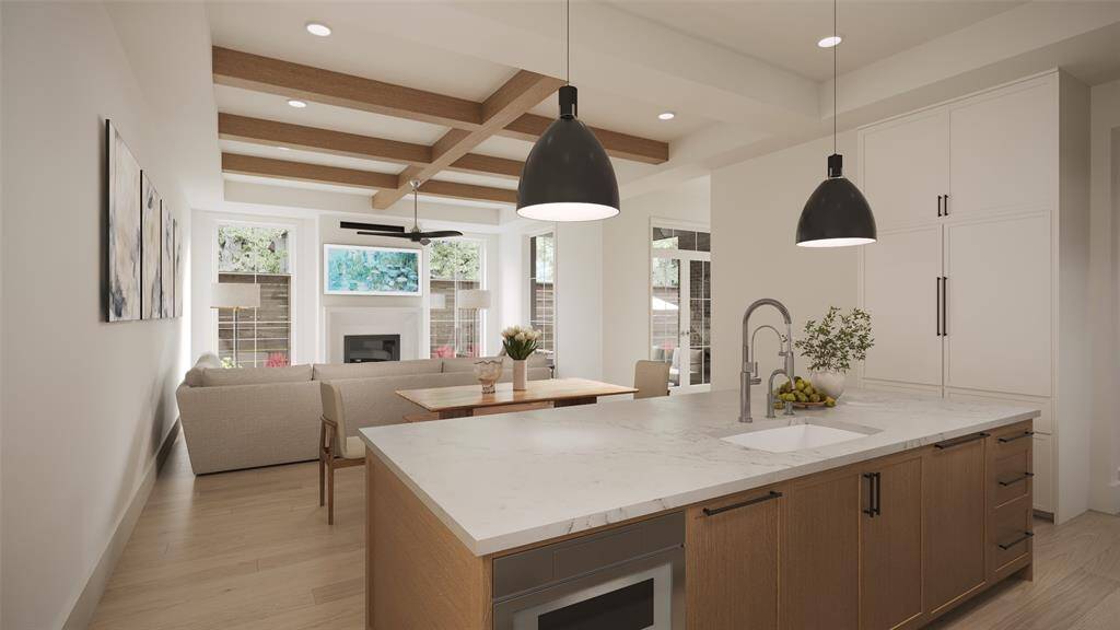 Another view of the Island Kitchen towards the Family Room with Two 17" Wide LED Pendent Lights in a Black Matte Finish, Blanco 33 1/2" Undermount Single Basin SILGRANIT Kitchen Sink.  There is a Brizo Single Hole Pre-Rinse Pull Down Kitchen Faucet and a Brizo Cold Only Water Dispenser Beverage Faucet.
