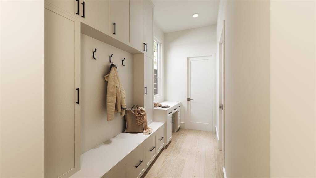 Mudroom Area in between the garage entrance and the Kitchen! Built-In Bench with Lower Cabinets, 1 x 6 Paneled Back with Hooks, Side Cabinets and Upper Cabinets.  There is also a built-in desk area.