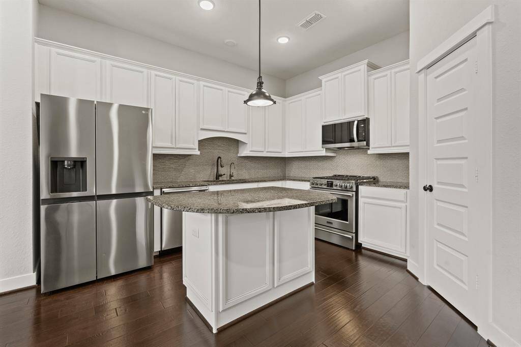 Stainless steel appliances and island with plenty of seating.