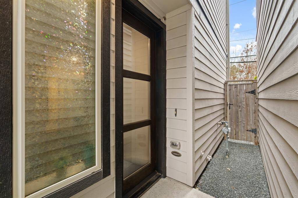 Front door at the side of house for privacy with gate to backyard.