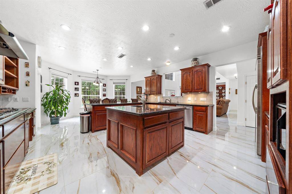 Open kitchen with an island and large windows
