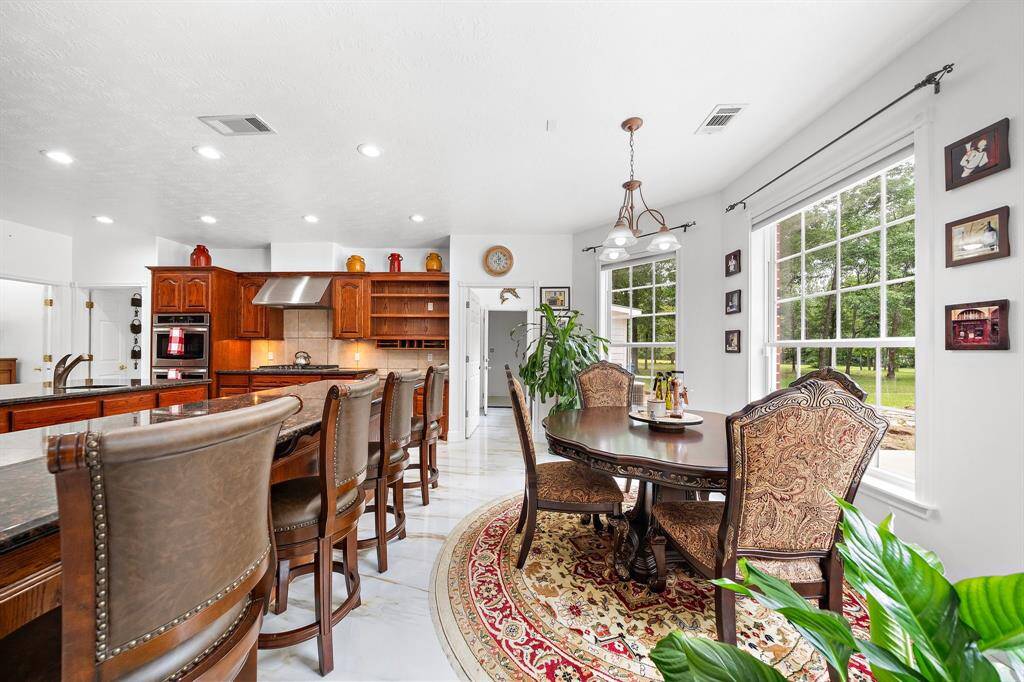 Cozy dining area next to the kitchen with large windows