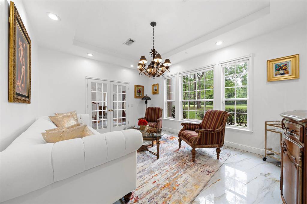 Charming sitting area with large windows and bright walls