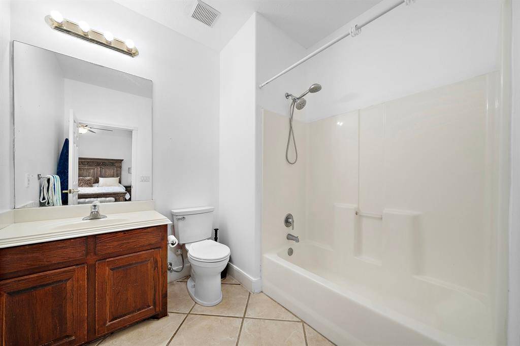 Simple bathroom with a shower-tub combination.