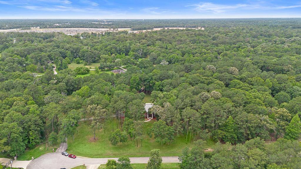 Expansive aerial view of the property within a lush forest