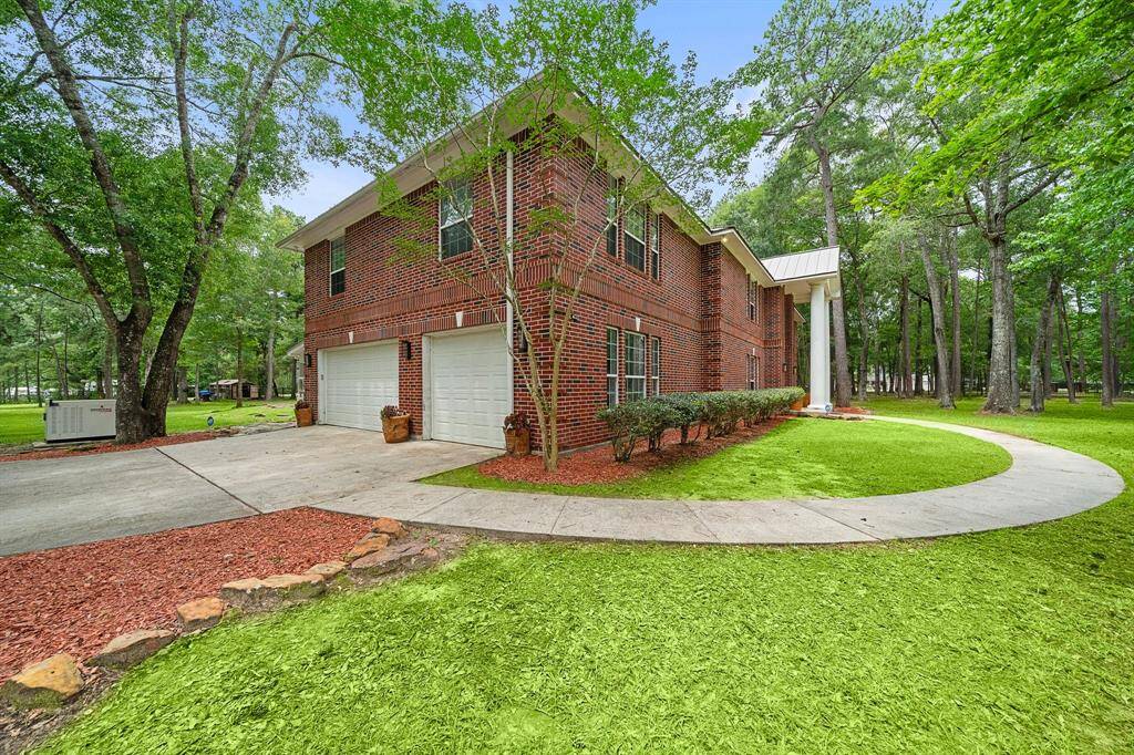 Welcome to 21992 Blazing Trail, New Caney, Texas, 77357, with a welcoming driveway and landscaped surroundings.