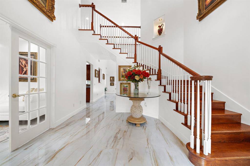Elegant foyer with a grand staircase and polished floors