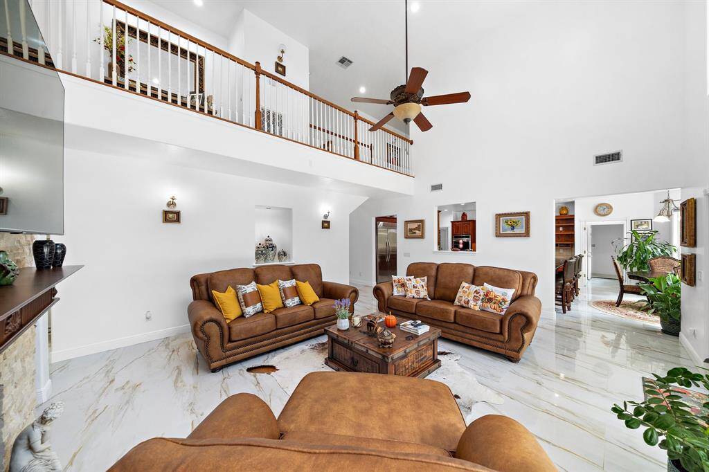 Spacious living room with an open layout and balcony view.