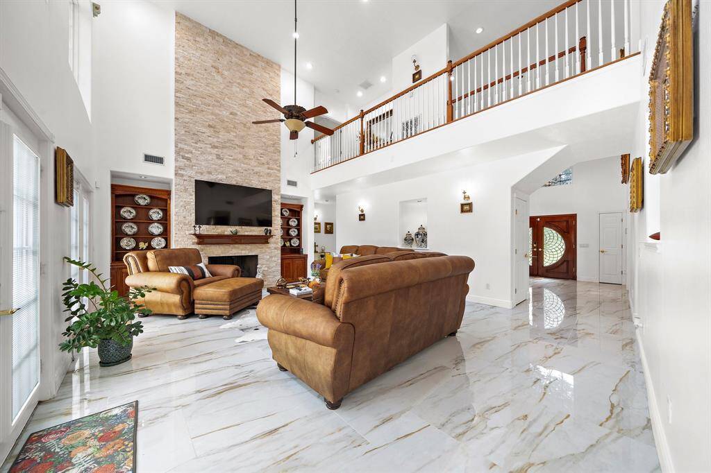Bright living room with a fireplace and balcony view