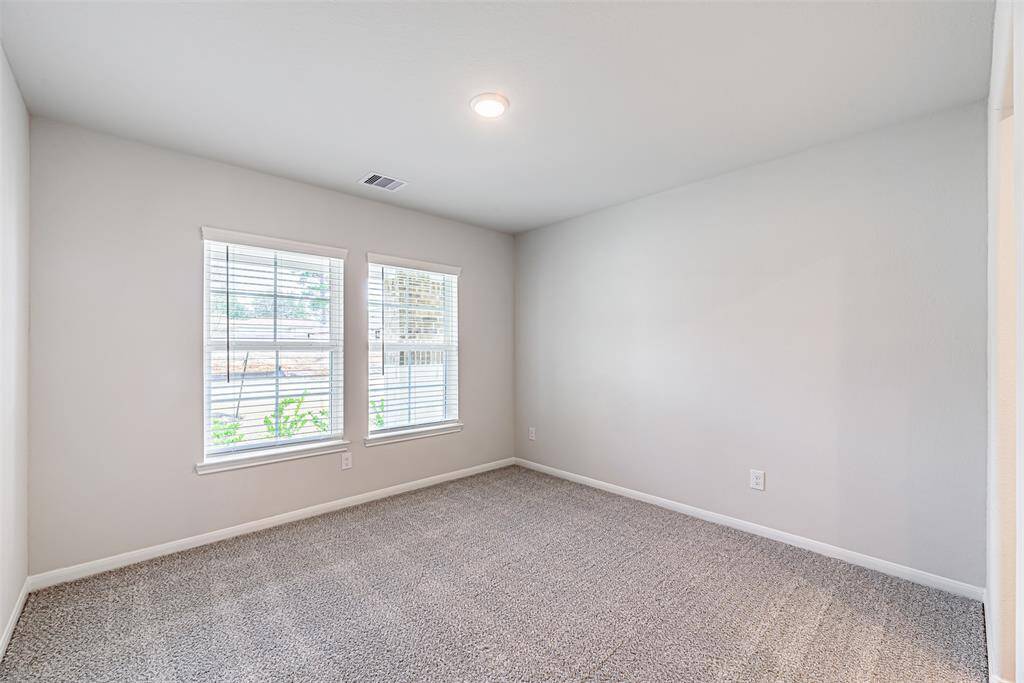 Secondary bedroom with carpet, canned lighting and double windows. Fan will be added.