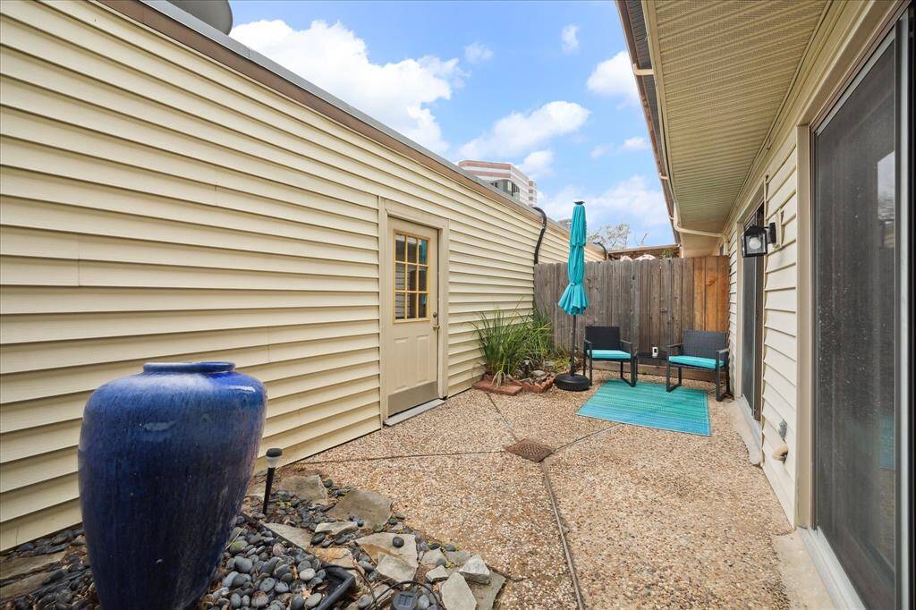 Step through the sliding glass doors into the quaint patio. Spacious enough for outdoor furniture, enjoy your morning coffee or a glass of wine. The stylish blue fountain adds a vibrant touch!