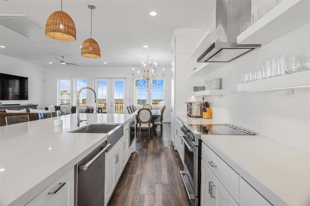 What a view of the Gulf of Mexico from the kitchen! Extra large quartz island with stainless steal Frigidaire appliances