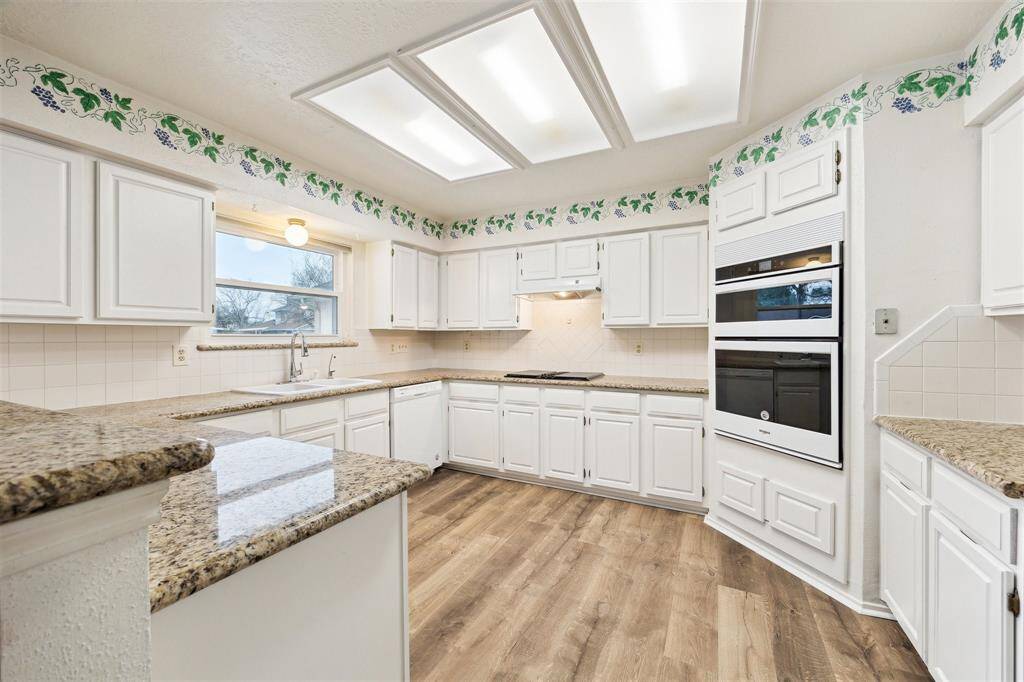 Lots of cabinets in this updated kitchen. Lower cabinets have pull out drawers.