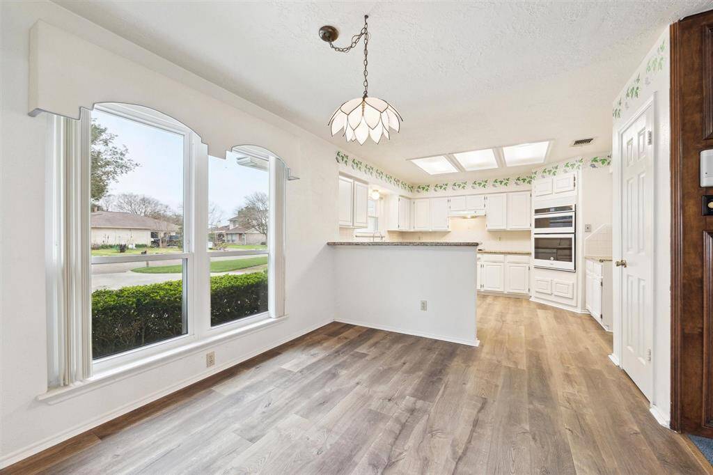 Breakfast room next to kitchen with breakfast bar.