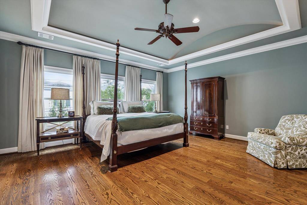 Expansive primary suite with marble bathroom and his/hers closets.