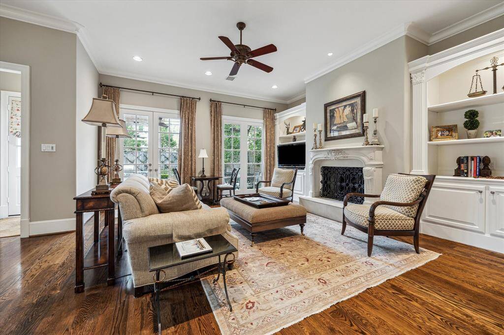 Roomy family room with lighted built-ins and French doors that open to back yard.