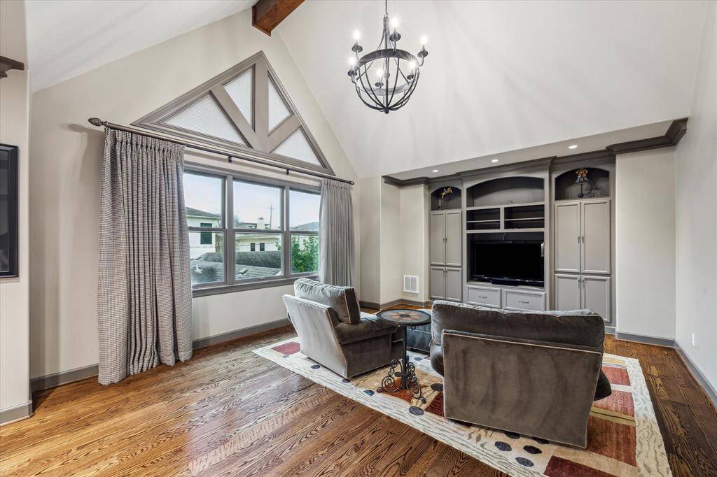 Game room with vaulted ceiling, built-in desks and storage and wiring for surround sound.