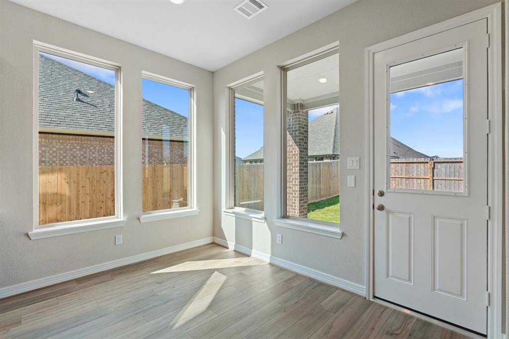 With an abundance of natural light streaming through the windows, the breakfast nook is bathed in a sunny glow, creating the perfect atmosphere to enjoy your morning coffee or a family breakfast.