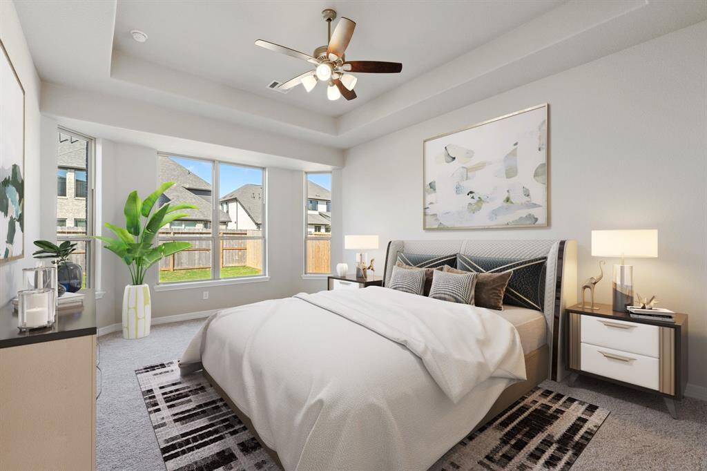 The primary bedroom is generously sized, creating a tranquil and spacious retreat that offers ample room for relaxation. Featuring plush carpet, high ceilings, fresh paint, and large windows that lets in natural lighting throughout the day. Photo is virtually staged