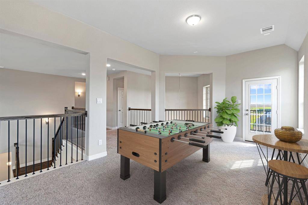 As you make your way upstairs this exceptional game room is a standout feature in this remarkable property, offering a space that combines luxury and fun for all ages. Photo is virtually staged