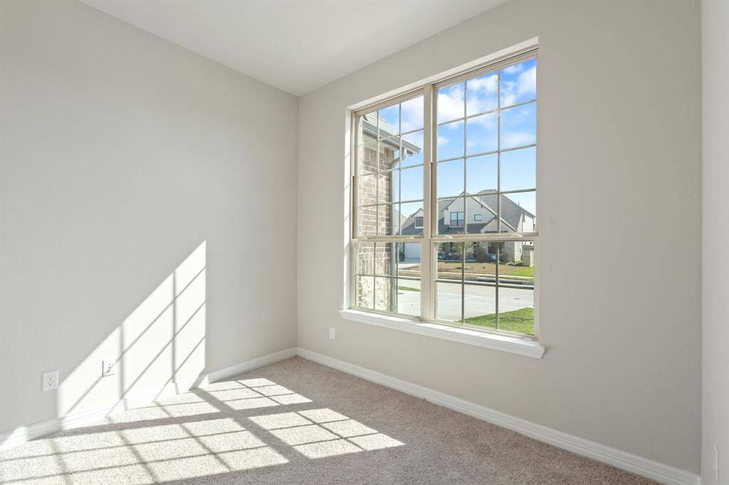 Your secondary bedroom features plush carpet, fresh paint, closet, and a large window that lets in plenty of natural lighting.