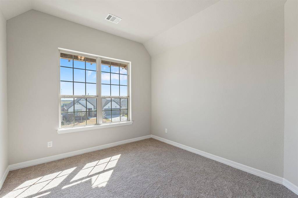 Your secondary bedroom features plush carpet, fresh paint, closet, and a large window that lets in plenty of natural lighting.