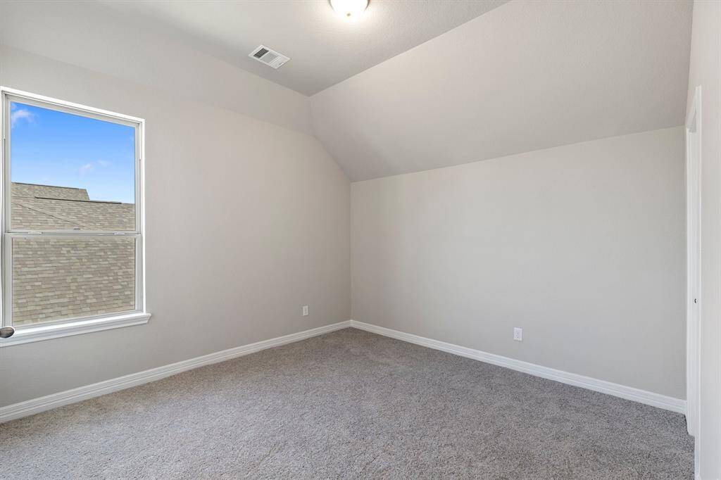 Your secondary bedroom features plush carpet, fresh paint, closet, and a large window that lets in plenty of natural lighting.