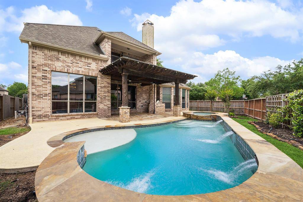 Water features in the pool and a spillway over the side of the hot tub.