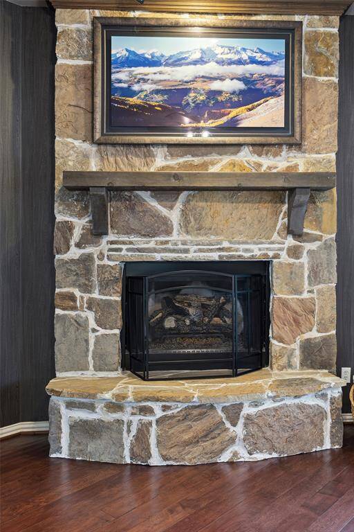 The stone fireplace with wood mantel is a stunning focal point in the Den.