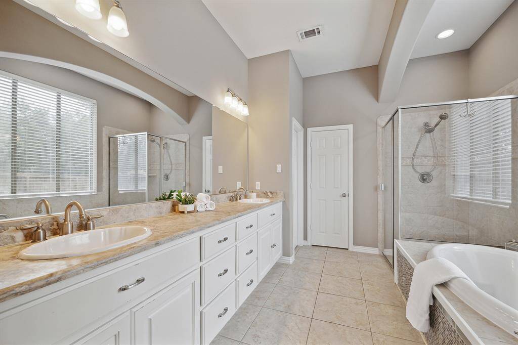 Ensuite Primary Bathroom with double sinks, separate shower and soaking tub.