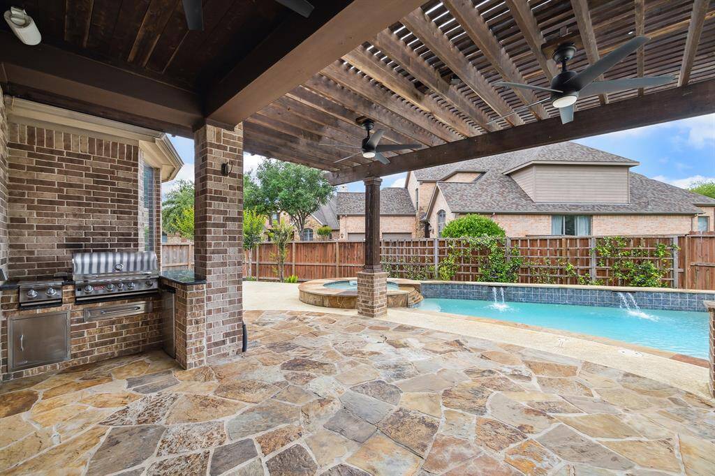 Covered patio with Outdoor Kitchen.  Notice the fabulous stonework.
