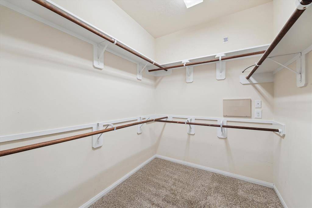 Primary spacious walk-in closet with ample storage space.