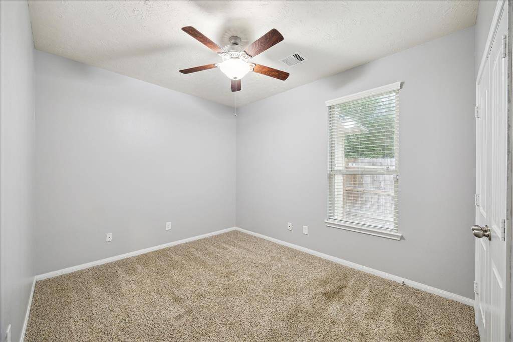 Second room features freshly painted soft gray walls and plush carpet