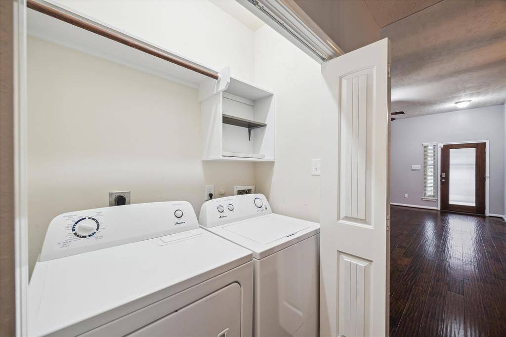 Laundry area, tucked neatly behind folding doors. It is adjacent to a living space, offering convenience and accessibility.