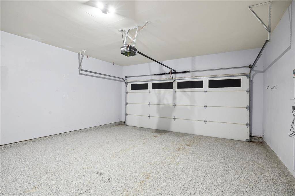Roomy two car garage with polyurethane flooring.